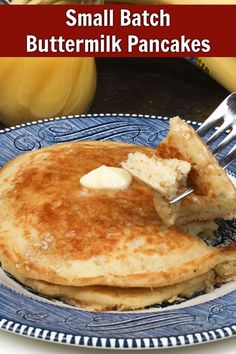 small batch buttermilk pancakes on a blue plate with a fork and bananas in the background