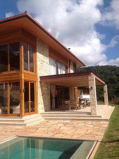 a house with a pool in front of it