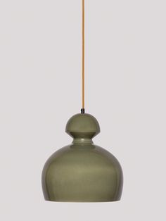 an olive green hanging light with a wooden stick sticking out of it's end