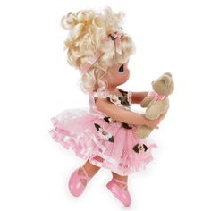 a doll with blonde hair holding a teddy bear in her hands and wearing pink shoes