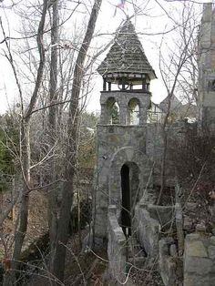 an old stone building with a clock tower in the middle of it's ruins