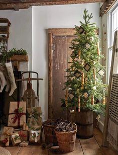 a small christmas tree sitting in front of a fireplace