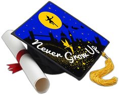 a graduation cap with the words never grow up on it and a tassel next to it