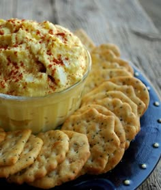 a plate with crackers and dip on it