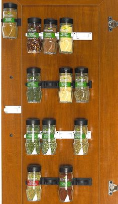 a wooden spice rack with spices and seasonings on it