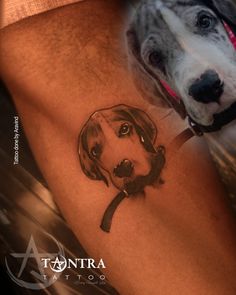 a dog tattoo on the leg of a person's leg, with a black and white drawing of a dog