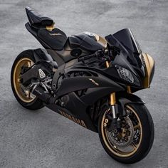 a black and gold motorcycle parked on the street