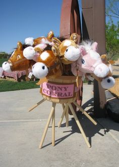 there are many stuffed animals in a basket on the street corner, and one is holding a sign that says pony coral