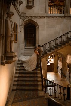 a bride and groom are standing on the stairs in an old building holding each other