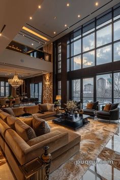 a large living room with high ceilings and floor to ceiling windows