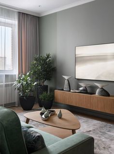 a living room filled with furniture and a flat screen tv mounted on a wall above a wooden coffee table