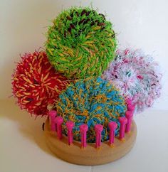 three different colored hairbrushes sitting on top of each other in front of a white wall