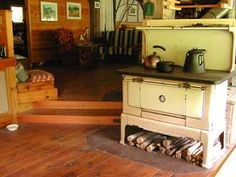 an old fashioned stove sitting on top of a wooden floor