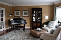 a living room filled with furniture and a piano