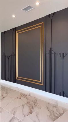 an empty room with marble flooring and walls painted in black, gold and white