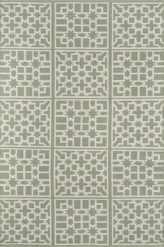 a green and white rug with an intricate design