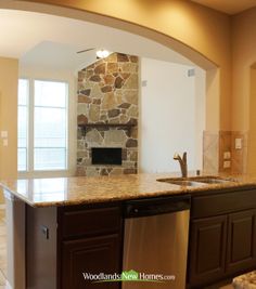 a kitchen with an oven, dishwasher and sink in the middle of it