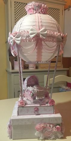 a pink and white carousel on top of a table