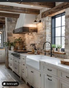 a kitchen with white cabinets and wooden beams on the ceiling is decorated in rustic style