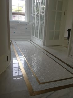 an empty room with white walls and marble flooring