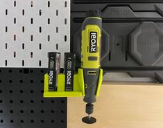 a cordless drill and two batteries on a shelf