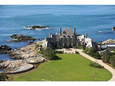 an aerial view of a large house on the ocean