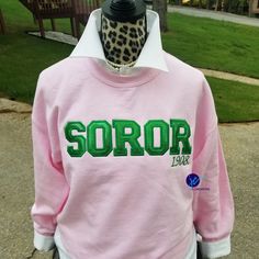 a pink sweatshirt with the word soror on it and a leopard print hoodie