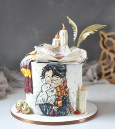 a cake decorated with an image of a woman holding a baby and candles on top