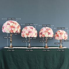 three vases with flowers are on a table and the measurements show how tall they are