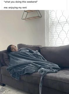 a woman laying on top of a couch covered in a blanket with the caption, what you doing this weekend? me enjoying my rent