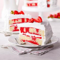 a slice of cake with white frosting and strawberries on top