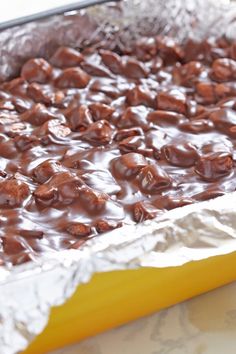 there is chocolate on top of aluminum foil in the pan, ready to be baked