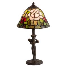 a table lamp with a stained glass shade on the base and a flower design at the bottom