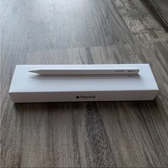 an apple pencil in its box on the floor