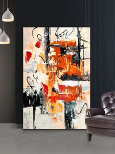 an abstract painting on the wall next to a chair