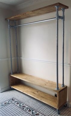 a wooden bench sitting in the middle of a room next to a wall mounted shelf