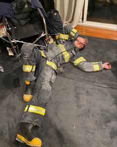 a fireman laying on the floor with his feet up