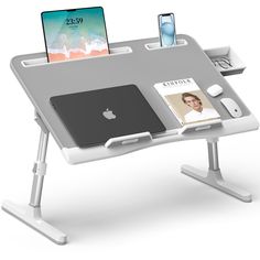 a computer desk with an ipad and other electronics on top of it, attached to a tabletop