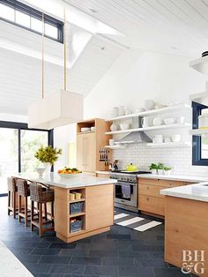 a kitchen with an island, stove and sink in it's center area is shown