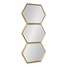 three hexagonal mirrors hanging on the wall