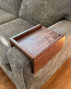 a wooden tray sitting on top of a couch