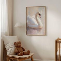 a baby's room with a swan painting on the wall and a teddy bear