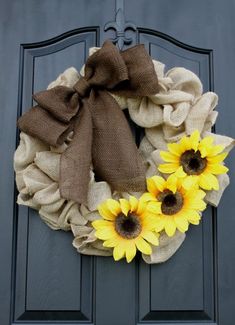 a wreath with burlocks and sunflowers on the front door