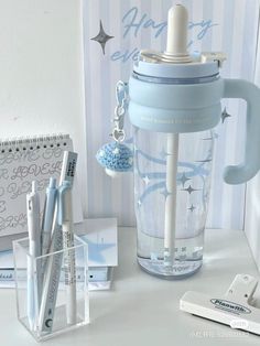 a blue blender sitting on top of a table next to a notepad and pen