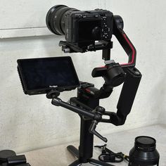 a tripod mounted to the side of a wall with a camera attached to it