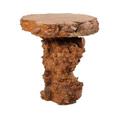 a piece of wood sitting on top of a white surface next to a tree stump