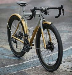 a close up of a bike parked on the side of a road with no wheels