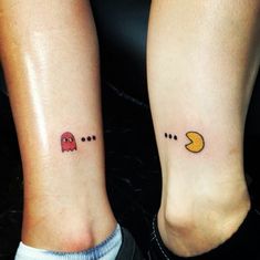 two people with matching tattoos on their feet, one has a pacman and the other has a moon