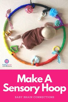 a baby is laying on top of a toy circle with toys around it and the words make a sensory hoop