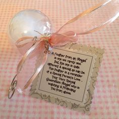 an ornament with a poem attached to it on a pink and white checkered table cloth